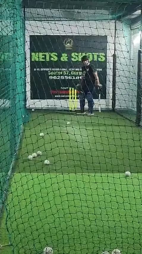 A batter in an indoor net at Nets & Shots